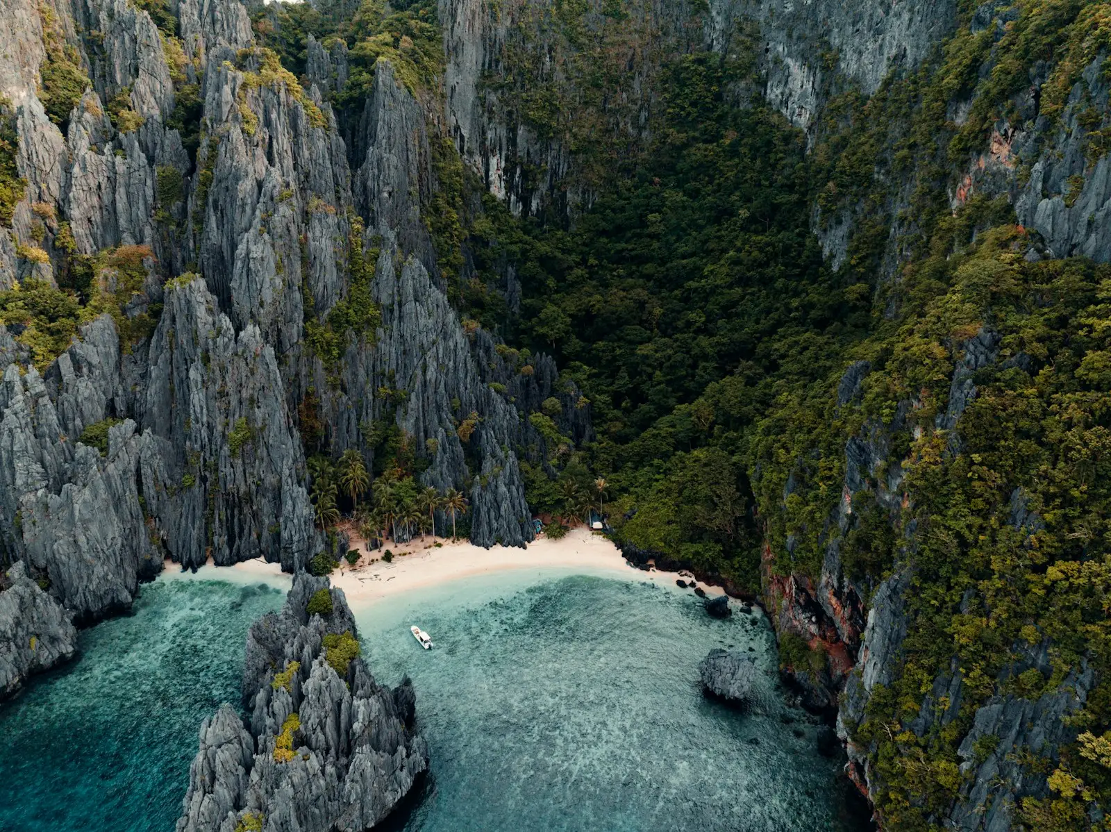 Tropical island cove with limestone cliffs and turquoise water in El Nido Palawan Philippines