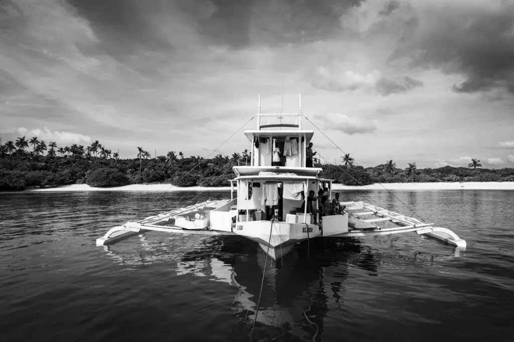 Traditional Filipino bangka boat on calm water, used for inter-island transport