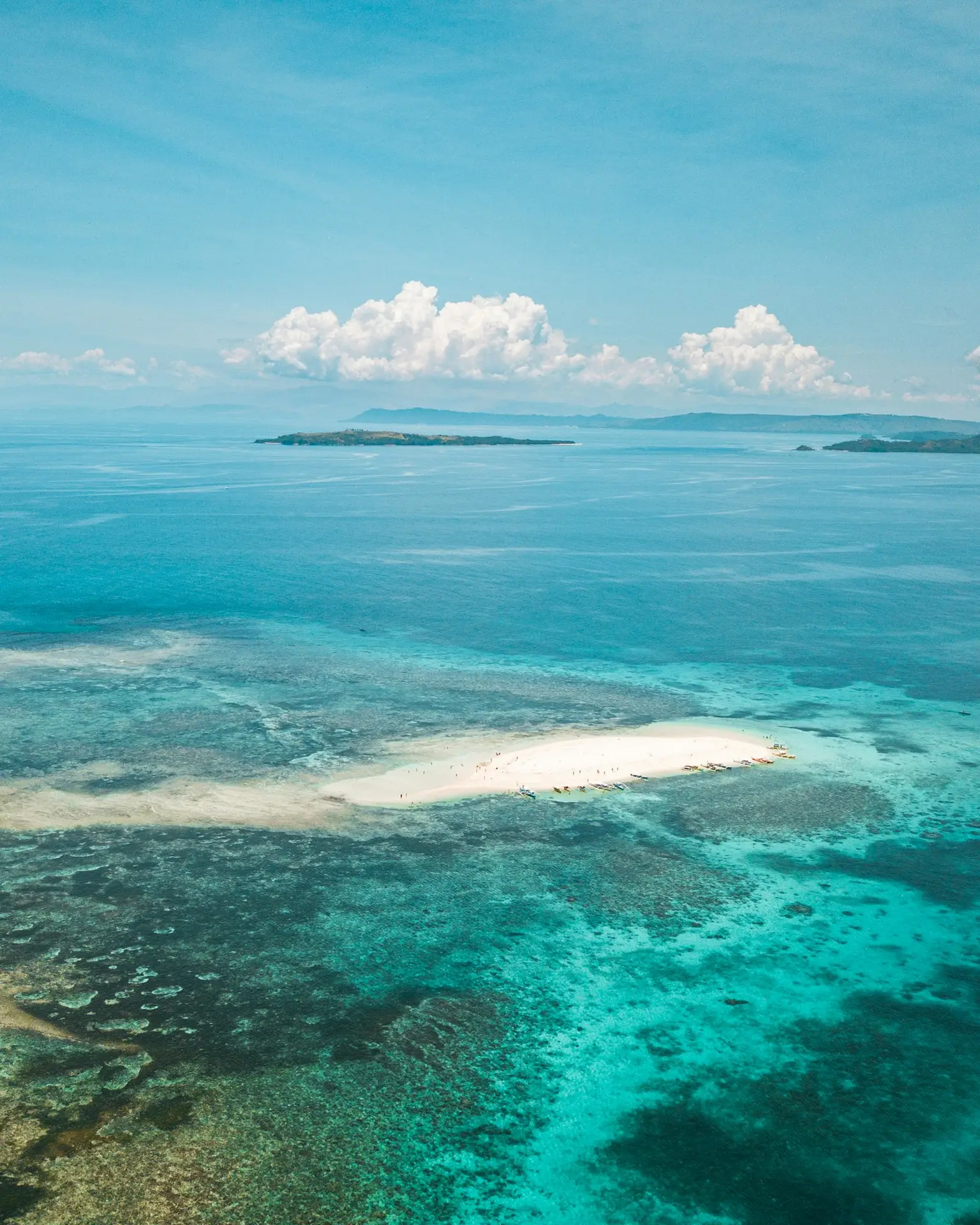 Aerial view of a Philippine island sandbar surrounded by turquoise water