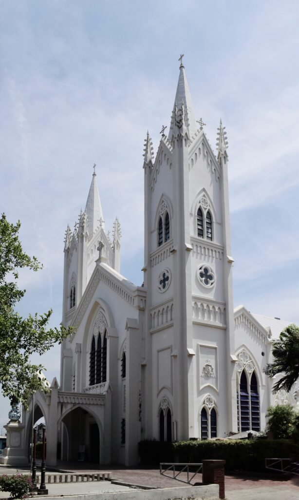 White cathedral with tall spires against a blue sky in Puerto Princesa City, Palawan, Philippines